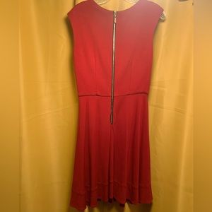 Elegant red dress that zips up the back and a twisted neckline.